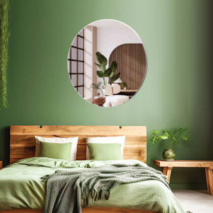 frameless oval mirror in bedroom